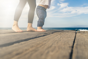 Baby boy walking on the beach in beautiful summer day