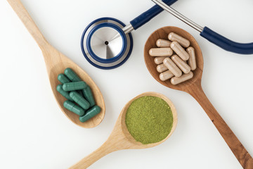 Herbal medicine in capsules with stethoscope