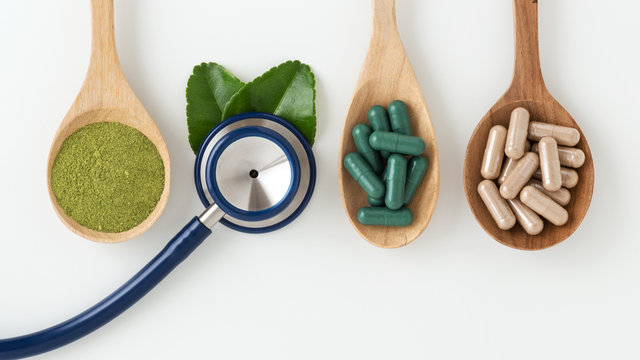 Herbal medicine with stethoscope on white background