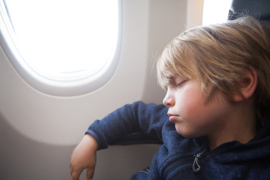 Little boy sleeping in an airplane