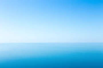 Zelfklevend Fotobehang Beautiful seascape without clouds. Perfectly clean smooth sea and clear blue sky © udovichenko