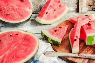 Watermelon and pieces of fruit in a wooden background. Antioxidant summer food.Selective focus.
