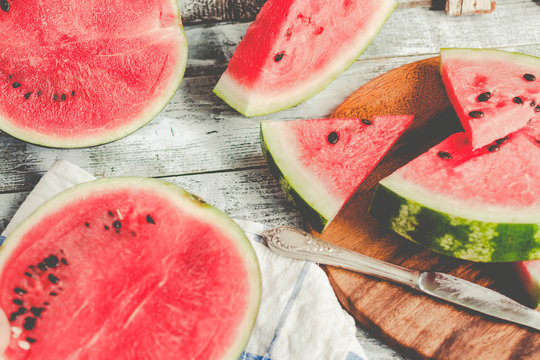 Watermelon and pieces of fruit in a wooden background. Antioxidant summer food.Tone.