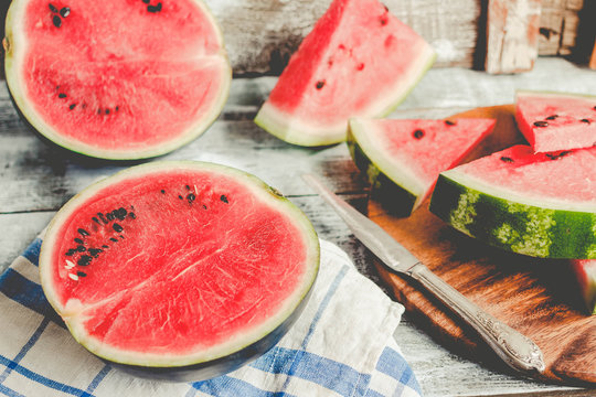 Watermelon and pieces of fruit in a wooden background. Antioxidant summer food. Toning.
