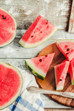 Watermelon and pieces of fruit in a wooden background. Antioxidant summer food.Selective focus.