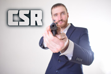 The businessman holds a gun in his hand and shows the inscription:CSR