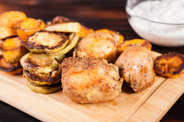 Plate with fried chicken and grilled vegetables. Zucchini and sweet potatoes
