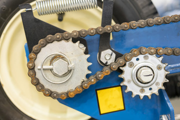 Close up of chain on gear on agricultural machine