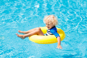 Child in swimming pool. Kids swim. Water play.