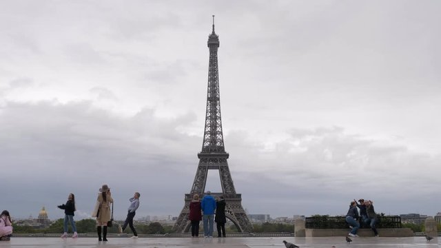 PARIS, FRANCE - SEPTEMBER 29, 2017: Slow motion shot of tourists enjoying cityscape and taking photos with Eiffel Tower being at the viewing point