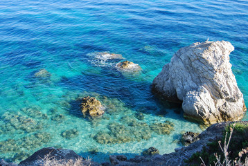 White rocky outcrops the blue and crystalline sea
