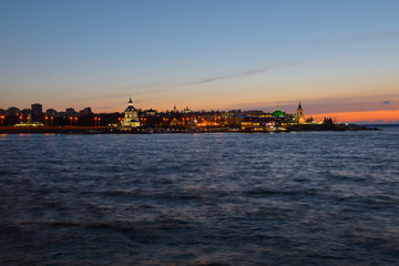Fototapeta premium May 3, 2018: Photo of the Volga embankment with the historical part of Cheboksary on a spring evening. Cheboksary. Chuvashia. Russia.