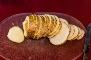 sliced russet potato being prepped for baking