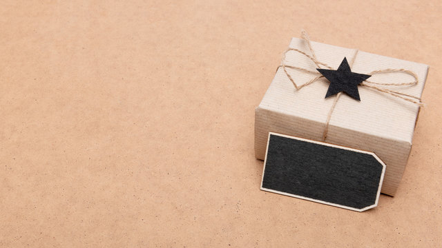 Happy Father's Day Background. Beautiful retro style gift box and black bow tie on brown background. Fathers day still life.