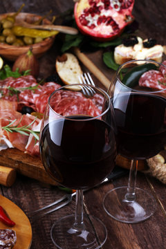 Italian antipasti wine snacks set. Cheese variety, Mediterranean olives, pickles, Prosciutto di Parma and salami