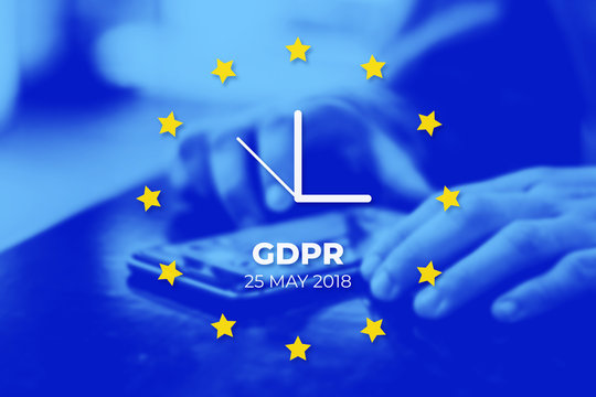 GDPR - General Data Protection Regulation. EU flag with clock, blue photo background. User protects their data on a mobile phone - Powered by Adobe
