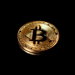 Gold Bitcoin isolated on black background with reflection.