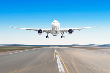 Naklejka na ściany i meble Passenger aircraft with on the asphalt landing on a runway airport, motion blur.