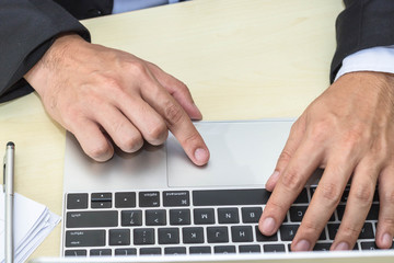 business man type job on laptop in office