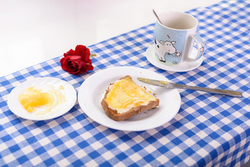 a cup of tea, a piece of toast with honey for breakfast