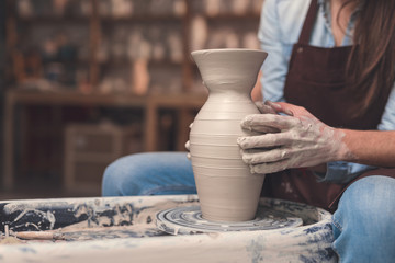 Young couple working on a potter's wheel