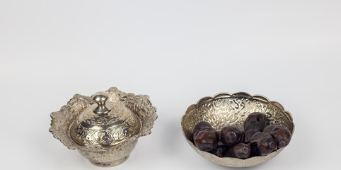 Ramadan dates religious month and silver islamic culture decoration on white background with breaking fast food, islamic muslim fasting