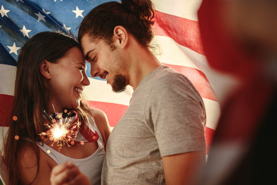 American couple celebrating independence day - Powered by Adobe