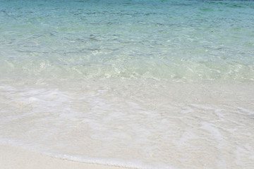 Wave of the sea on the white sand beach..