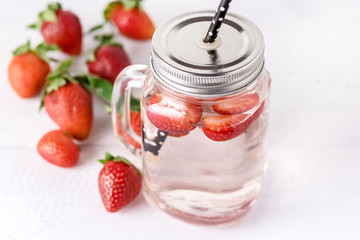 Mug of Delicious Refreshing Drink of Strawberry on White Wooden Background Infused Detox Water Above