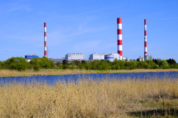 Warsaw, Poland - Siekierki Power and Heat Plant in Czerniakow quarter of Warsaw neighboring Czerniakowskie Lake nature reserve - obrazy, fototapety, plakaty