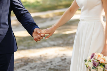 Bride and groom holding hands at wedding day