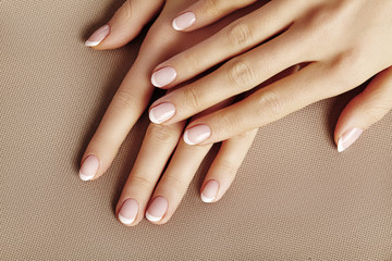 Young Female Palm. Beautiful Glamour Manicure. French Style. Nail polish. Care about Hands and...