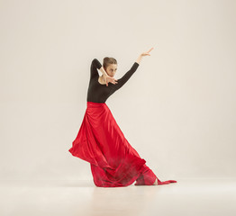 Modern ballet dancer dancing in full body on white studio background.