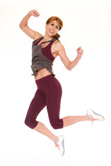 Fototapeta na wymiar Fitness woman jumping in studio