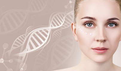 Sensual woman with cream dots on face in DNA chains.