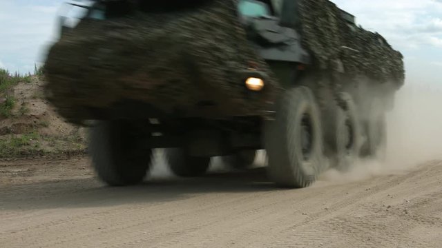 Armored military vehicle 8x8 wheeled BTR driving offroad in sand desert