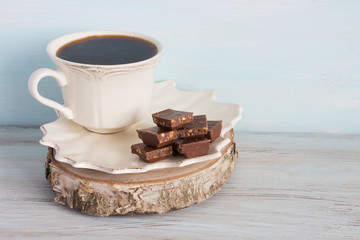 A cup of coffee with pieces of chocolate. Breakfast.