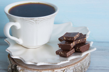 A cup of coffee with pieces of chocolate. Breakfast.