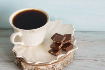 A cup of coffee with pieces of chocolate. Breakfast.