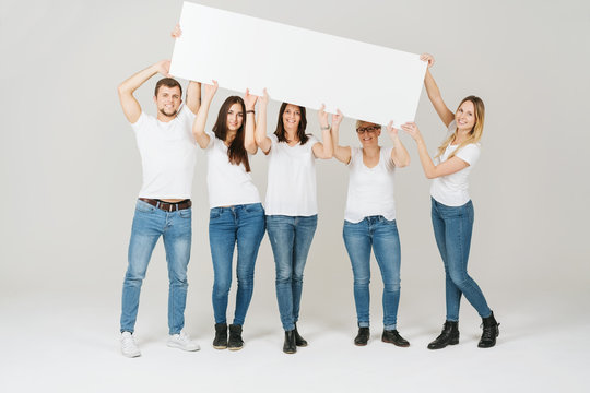 Group Of Five Friends Holding Up A Banner Sign