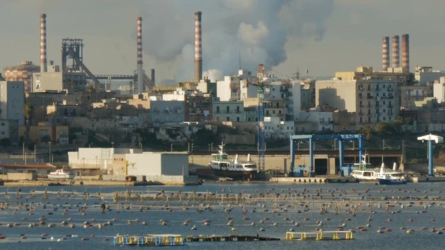 Industrial area and neighbourhood facing the sea in Taranto, in the south of Italy.