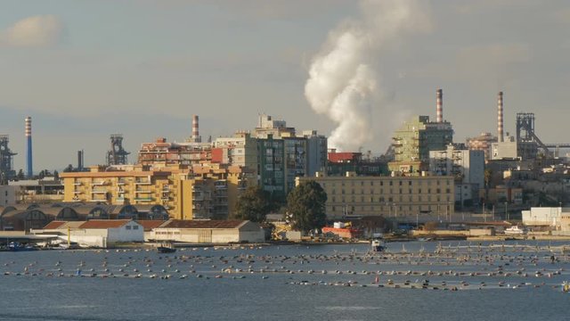 Industrial area and neighbourhood facing the sea in Taranto, in the south of Italy.