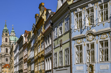 Fototapeta premium View on old city .Traditional medieval buildings .In the background could see the beautiful Cathedral of St. Nicholas. Sunny Morning. Prague, Czech Republic. European travel.