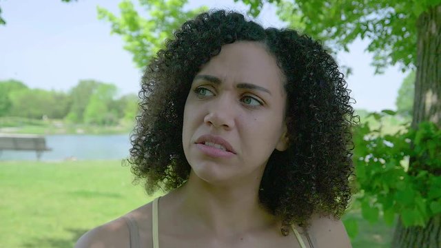 A woman is taken aback after receiving disappointing news.