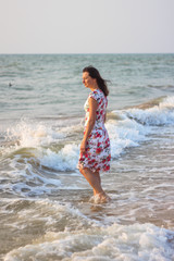 Fototapeta na wymiar woman in a beautiful dress near the sea at dawn