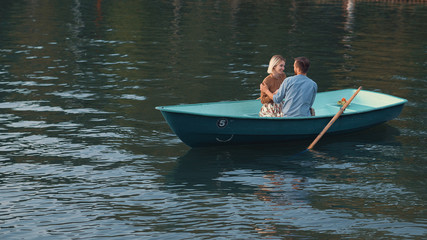 Attractive young couple in a boat