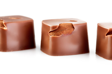 Assortment of chocolate candies sweets isolated on a white background. Chocolate candies collection. Milk chocolate with nuts.