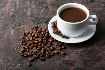Coffee beans and cinnamon on a background of burlap. Roasted coffee beans background close up. Coffee beans pile from top with copy space for text. Seasoning. Spice. Cinnamon. Badian. Coffee house.