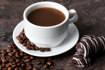 Coffee beans and cinnamon on a background of burlap. Roasted coffee beans background close up. Coffee beans pile from top with copy space for text. Seasoning. Spice. Cinnamon. Badian. Coffee house.