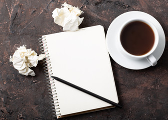 Blank paper waiting for idea with woman hand and pencil. Top View of Creative Writing Concept With Pencils, Coffee Cup, Notepad and Crumpled Paper on Table.